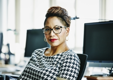 Portrait of woman in front of computers